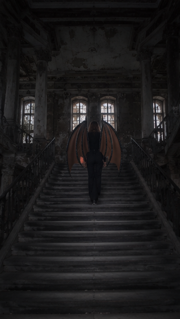 Person with glowing wings walking down a dark staircase in an abandoned building