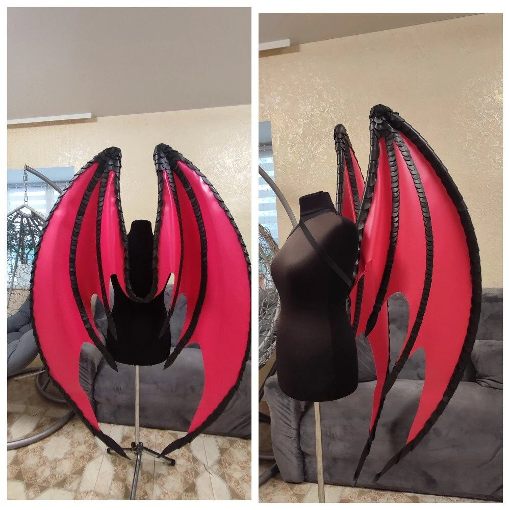 Red and black dragon wings on a mannequin against a neutral background