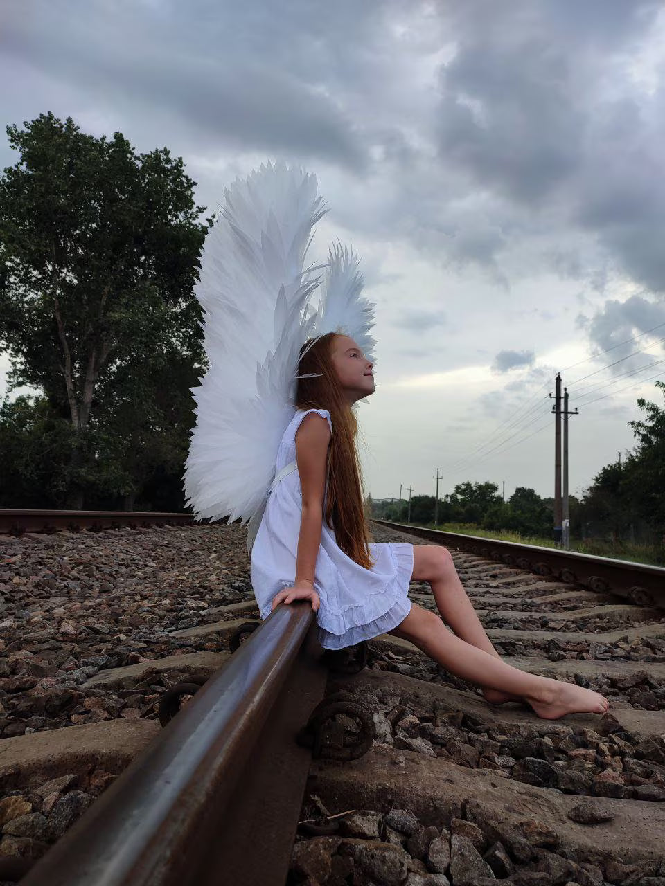 Premium handmade white angel wings featuring individually hand-cut foamed polyethylene feathers and durable construction